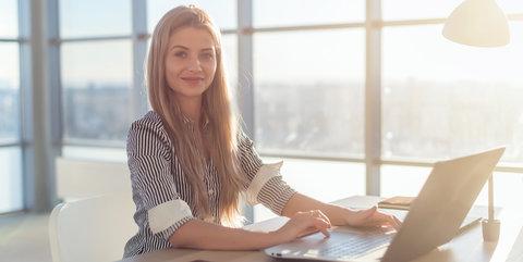 Junge Frau am Schreibtisch mit Laptop Junge Frau am Schreibtisch mit Laptop